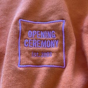 Opening ceremony sweater with orange on pink logo barely worn